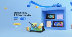 Promotional image for Black Friday and Cyber Monday showing various tablets and devices with a "Special Offer Up to 40% Off" text, a "Buy Now" button, and a large blue gift box in the background with ribbons and small decorations.